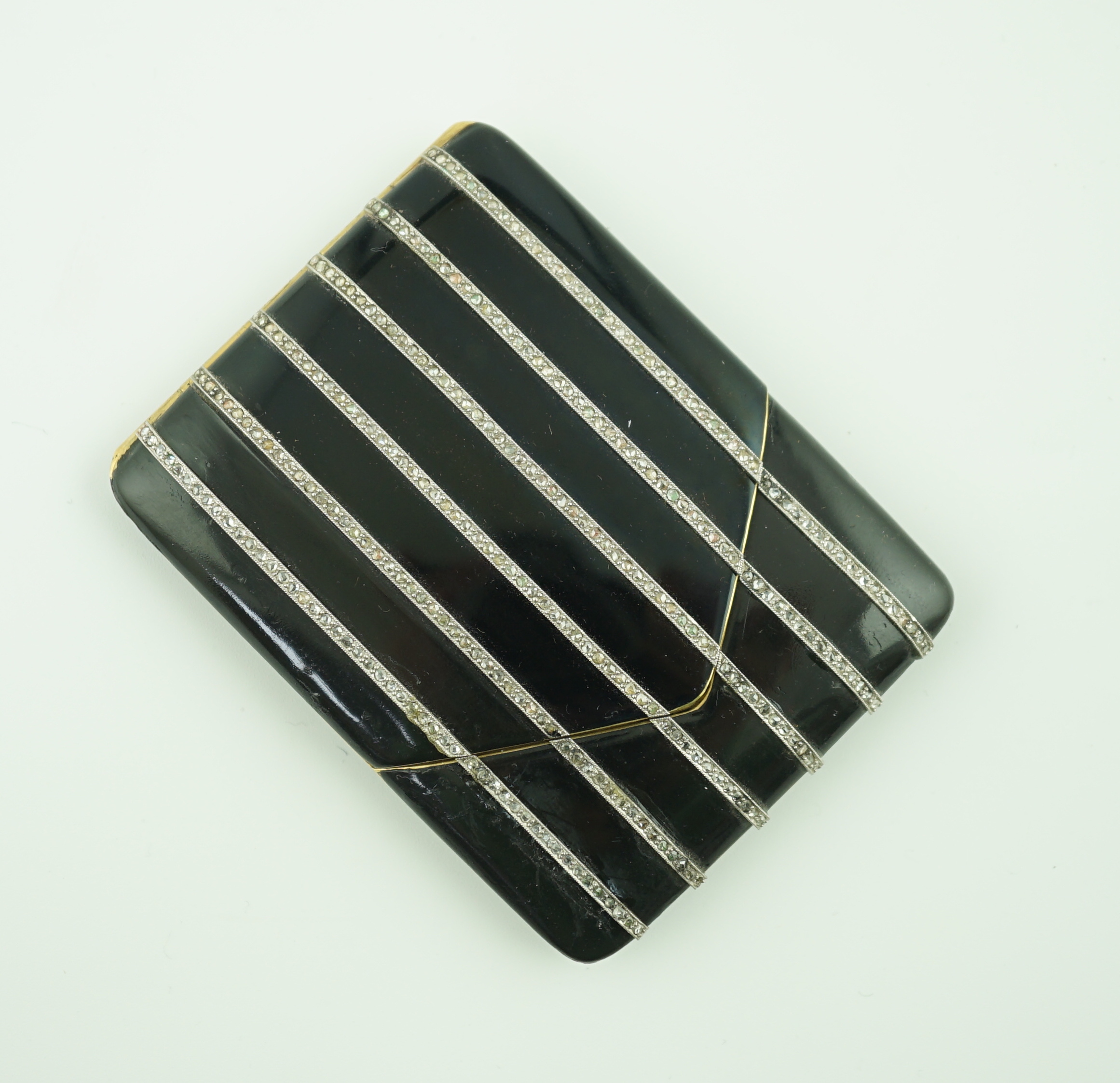 A 1920's gold and black enamel cigarette case, set with six rows of millegrain set rose cut diamonds